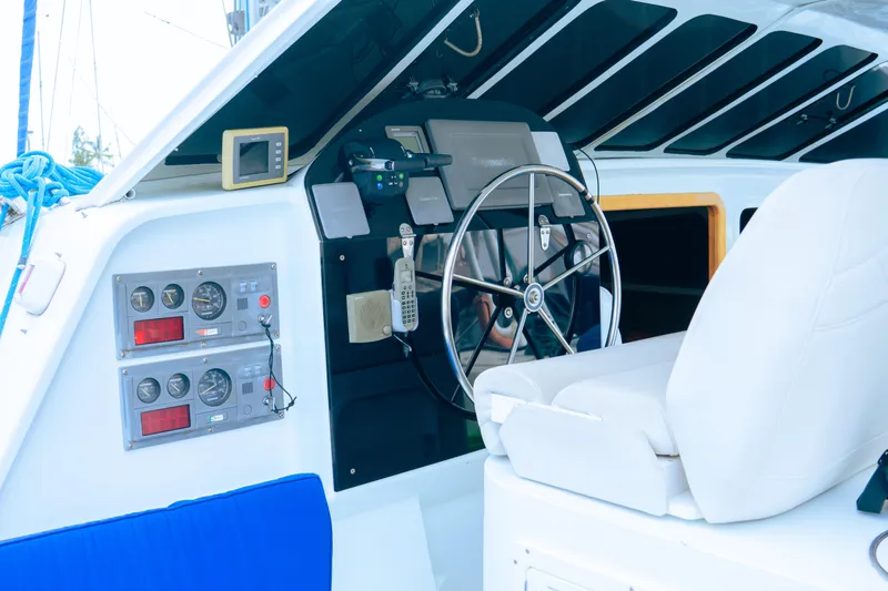 Leilani Yacht Photos Pics Luxury yacht cockpit with steering wheel, control panels, and white seating, 2005 model.