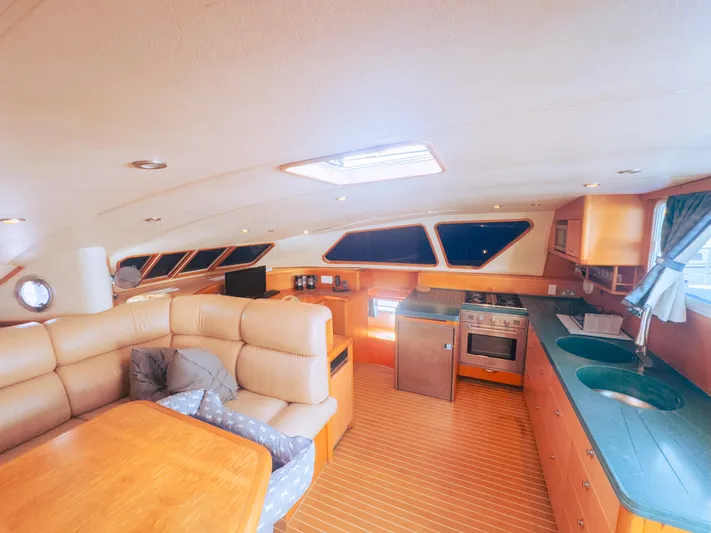 Leilani Yacht Photos Pics Luxurious yacht interior with modern kitchen and comfortable seating, 2005 Custom Luxury Performance model.