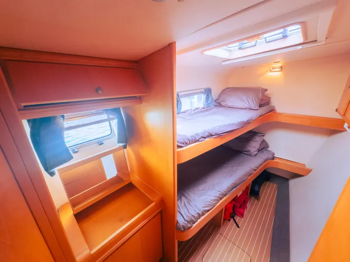 Leilani Yacht Photos Pics Luxurious 2005 custom yacht cabin with bunk beds and wooden interior.