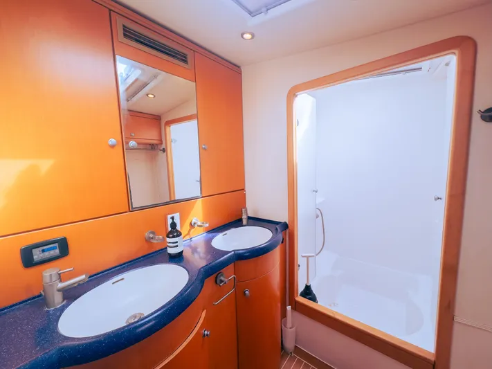 Leilani Yacht Photos Pics Luxurious yacht bathroom with dual sinks, wooden cabinetry, and spacious shower, 2005 model.