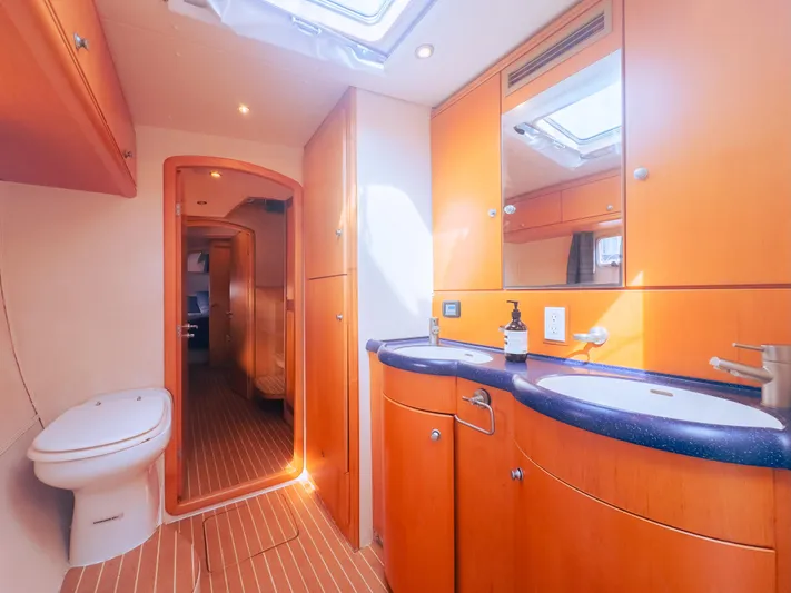 Leilani Yacht Photos Pics Luxurious yacht bathroom with wooden cabinetry, dual sinks, and modern fixtures, 2005 custom model.