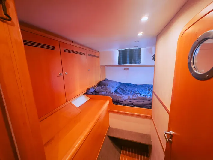 Leilani Yacht Photos Pics Luxurious 2005 custom yacht cabin with wooden interiors and cozy bedding.