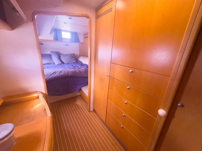 Leilani Yacht Photos Pics Luxurious 2005 custom yacht interior with cozy bedroom and elegant wooden cabinetry.