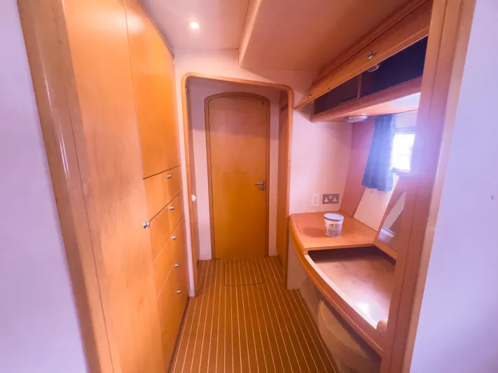 Leilani Yacht Photos Pics Luxurious wooden interior of a 2005 custom luxury performance model, featuring cabinets and a vanity.