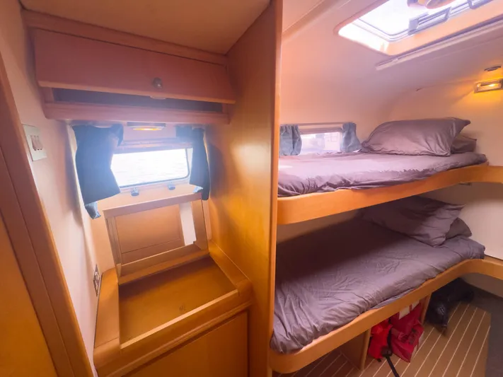 Leilani Yacht Photos Pics Luxurious 2005 custom yacht cabin with bunk beds and wooden interior.