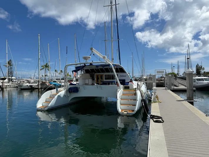Leilani Yacht Photos Pics Luxury performance catamaran docked at marina, clear sky, 2005 model.