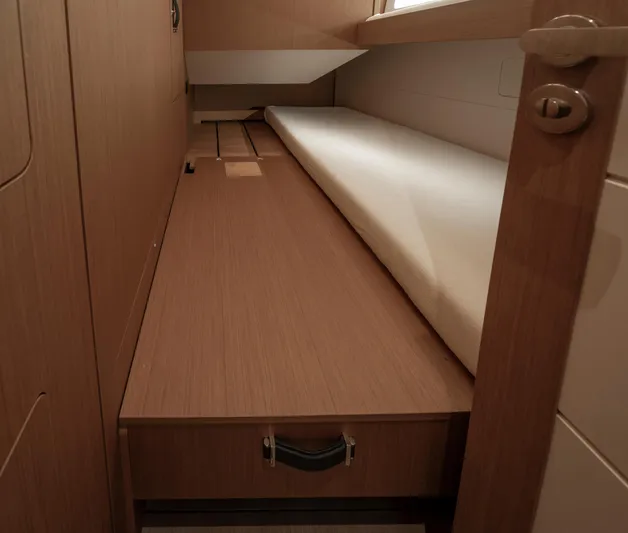  Yacht Photos Pics Interior cabin of 2022 Jeanneau Yacht 60 with wooden finish and storage drawer.