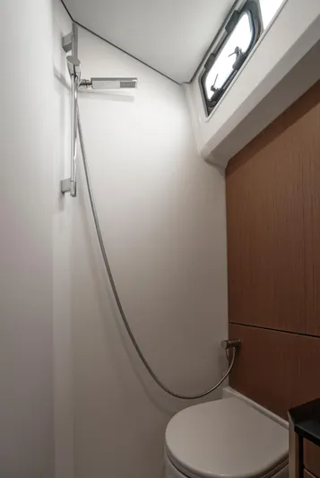  Yacht Photos Pics Bathroom interior of 2022 Jeanneau Yacht 60, featuring shower and toilet.