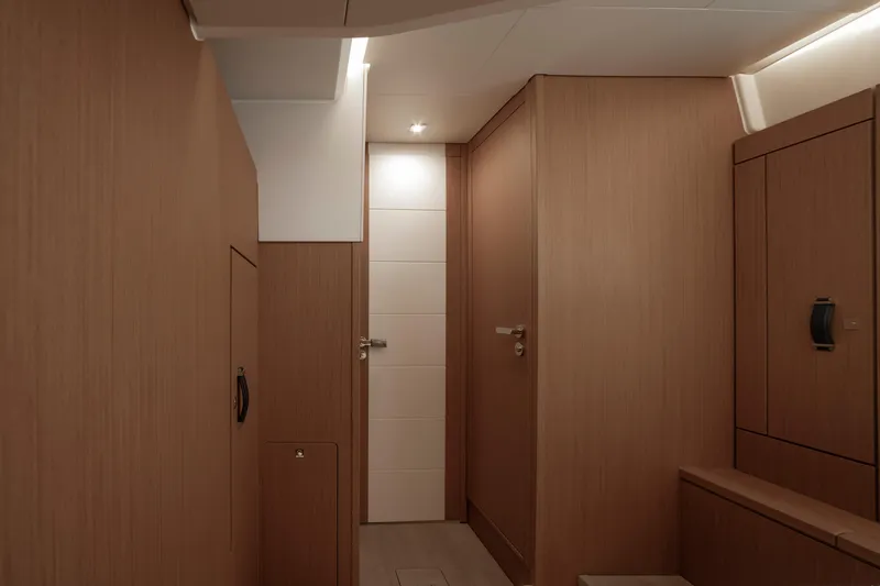  Yacht Photos Pics Interior of 2022 Jeanneau Yacht 60, featuring sleek wooden cabinetry and modern design.