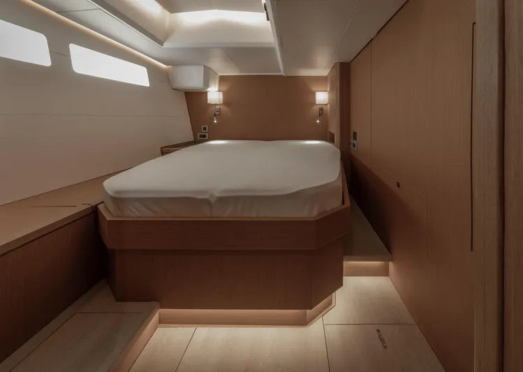  Yacht Photos Pics Luxurious cabin interior of 2022 Jeanneau Yacht 60 with modern wood finish.