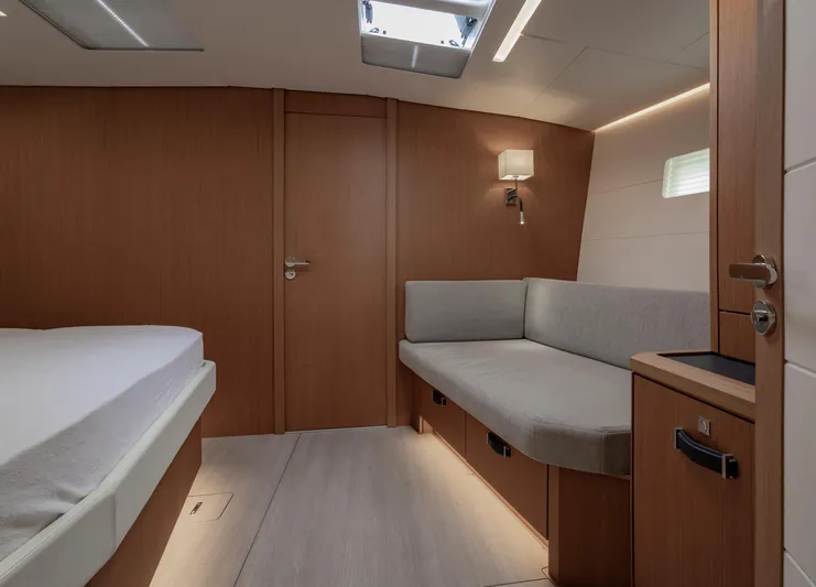  Yacht Photos Pics Luxurious interior of 2022 Jeanneau Yacht 60 with modern wood finish and cozy seating.