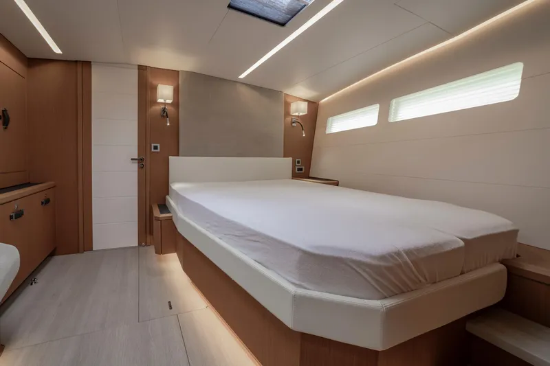  Yacht Photos Pics Luxurious interior of 2022 Jeanneau Yacht 60 with modern bedroom design.
