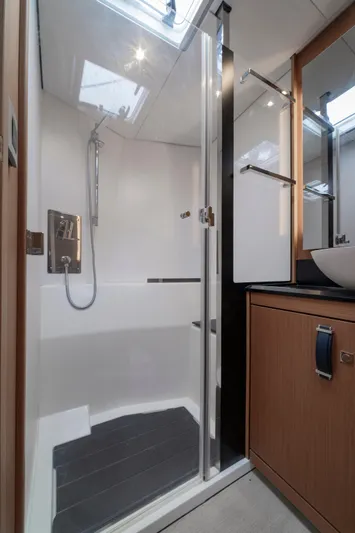  Yacht Photos Pics Modern bathroom in 2022 Jeanneau Yacht 60, featuring sleek shower and elegant fixtures.