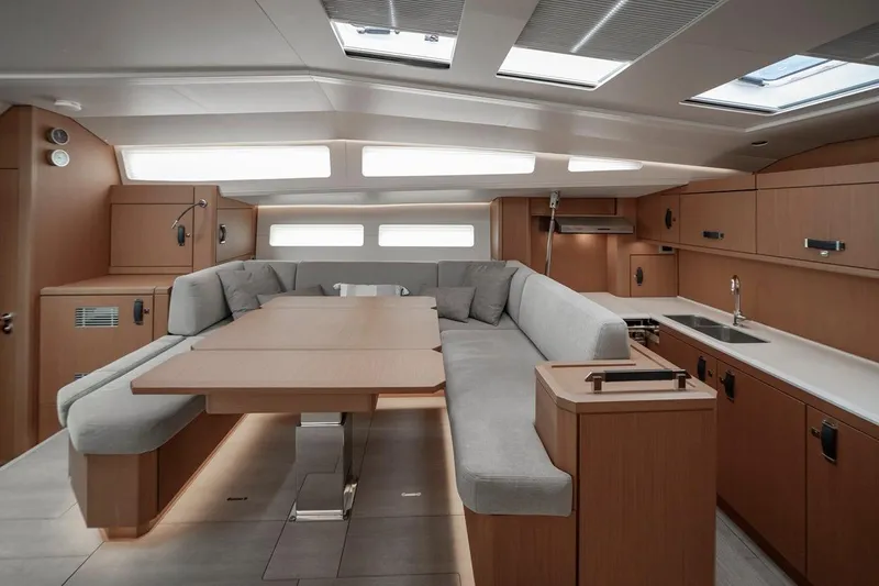  Yacht Photos Pics Luxurious interior of 2022 Jeanneau Yacht 60 with modern kitchen and seating area.