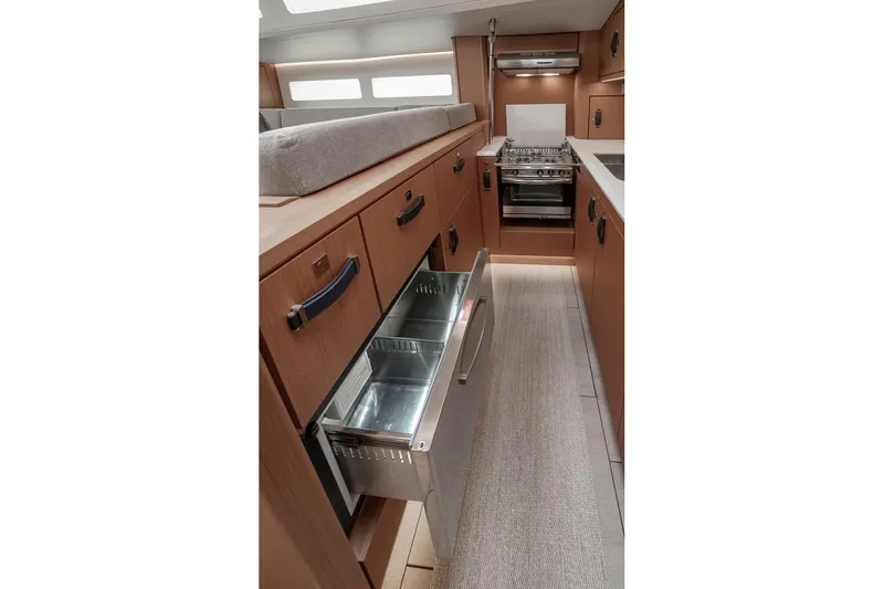  Yacht Photos Pics Modern kitchen interior of 2022 Jeanneau Yacht 60 with sleek cabinetry and appliances.