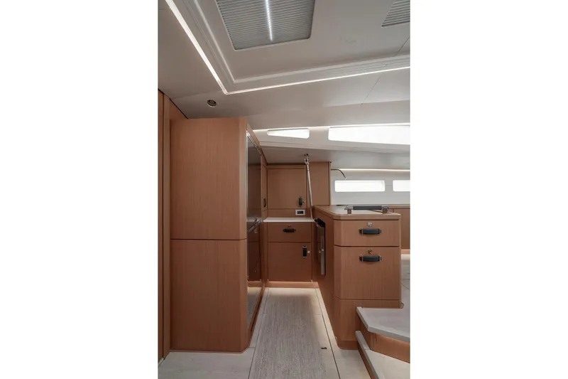  Yacht Photos Pics Luxurious interior of 2022 Jeanneau Yacht 60, featuring modern wood cabinetry and sleek design.