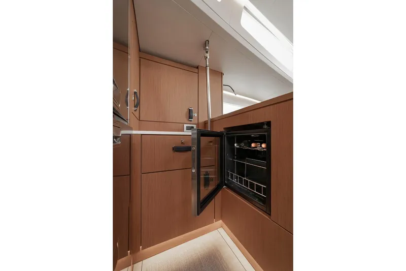  Yacht Photos Pics Luxurious interior of 2022 Jeanneau Yacht 60 with open wine cooler.