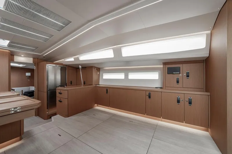  Yacht Photos Pics Luxurious interior of 2022 Jeanneau Yacht 60 with modern kitchen and sleek wood finishes.