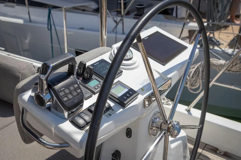  Yacht Photos Pics Steering wheel and controls of 2022 Jeanneau Yacht 60, featuring modern navigation equipment.