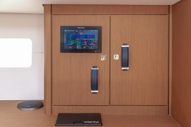  Yacht Photos Pics Control panel on Jeanneau Yacht 60, 2022 model, featuring sleek wooden cabinetry.