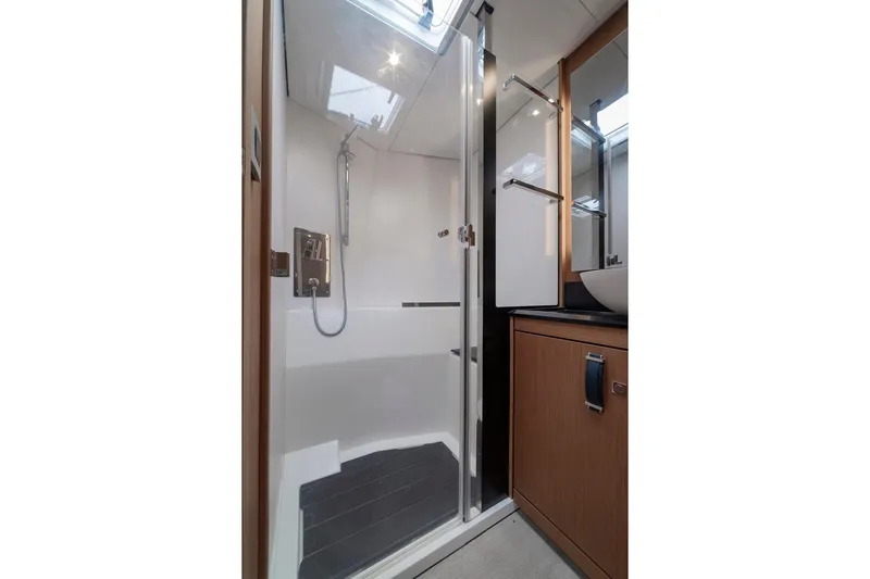  Yacht Photos Pics Luxurious bathroom in 2022 Jeanneau Yacht 60, featuring modern shower and sleek design.