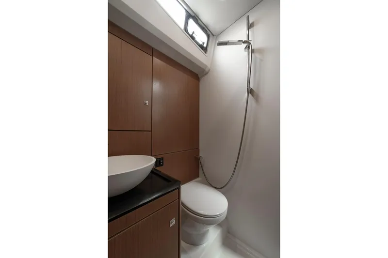  Yacht Photos Pics Luxurious bathroom in 2022 Jeanneau Yacht 60 with modern fixtures and elegant design.