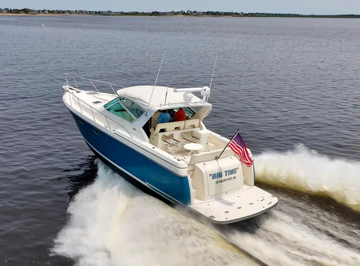 Big Time Yacht Photos Pics 1996 Tiara Yachts 3500 Express cruising with American flag waving.