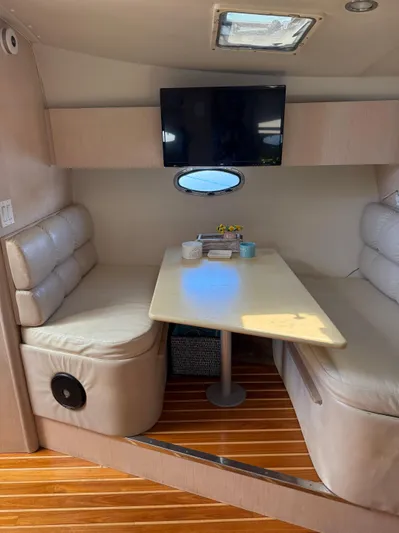 Big Time Yacht Photos Pics 1996 Tiara Yachts 3500 Express interior with table and seating area.