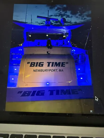 Big Time Yacht Photos Pics 1996 Tiara Yachts 3500 Express illuminated in blue at night.