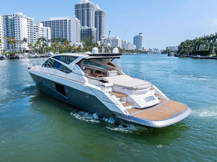 Minion Yacht Photos Pics Luxury 2014 Cranchi 56 HT yacht cruising in a scenic urban waterway.