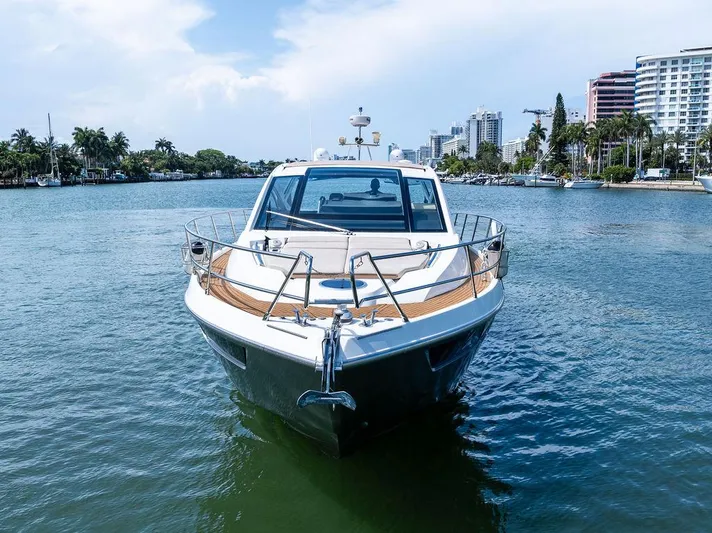 Minion Yacht Photos Pics 2014 Cranchi 56 HT yacht on a scenic waterway with city skyline.