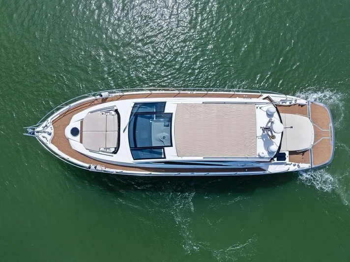 Minion Yacht Photos Pics Aerial view of 2014 Cranchi 56 HT yacht cruising on green water.