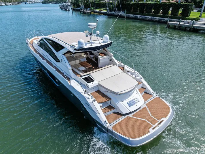 Minion Yacht Photos Pics Luxury 2014 Cranchi 56 HT yacht cruising on a serene waterway.