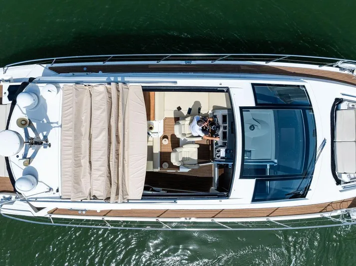 Minion Yacht Photos Pics Aerial view of 2014 Cranchi 56 HT yacht on water, showcasing sleek design and spacious deck.