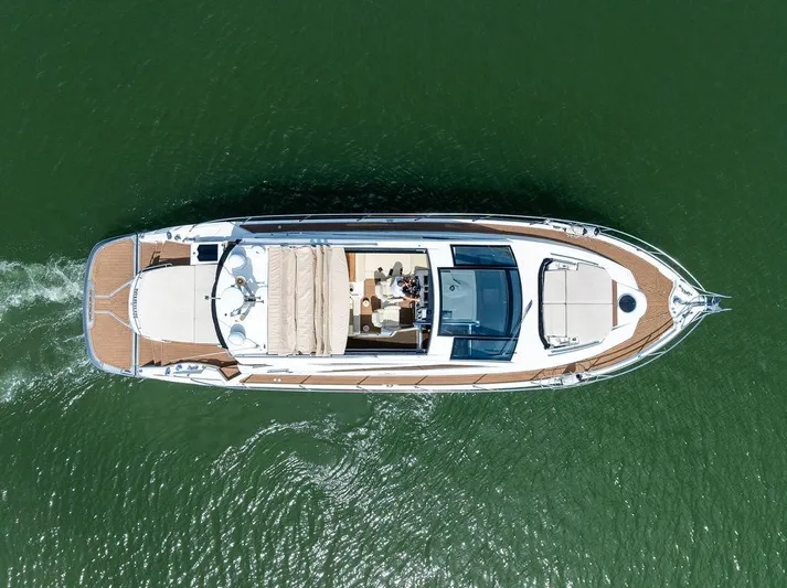 Minion Yacht Photos Pics Overhead view of 2014 Cranchi 56 HT yacht cruising on green water.