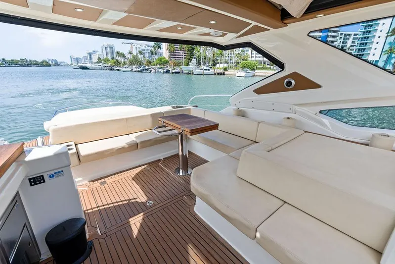 Minion Yacht Photos Pics Luxurious 2014 Cranchi 56 HT yacht interior with spacious seating and scenic waterfront view.