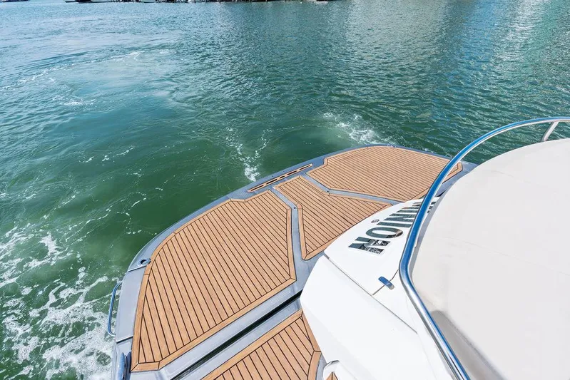 Minion Yacht Photos Pics Cranchi 56 HT 2014 yacht with teak deck on calm water.