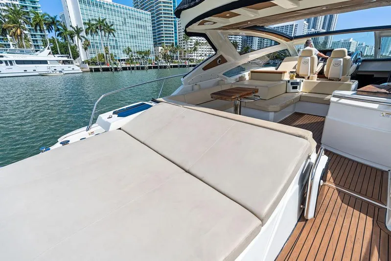 Minion Yacht Photos Pics Luxurious 2014 Cranchi 56 HT yacht with spacious deck and seating, docked in a marina.
