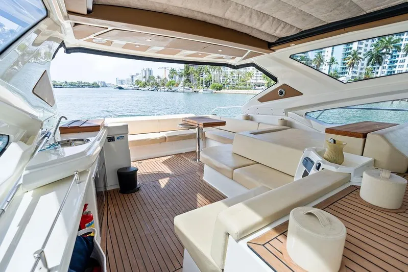 Minion Yacht Photos Pics Luxurious 2014 Cranchi 56 HT yacht interior with elegant seating and scenic waterfront view.
