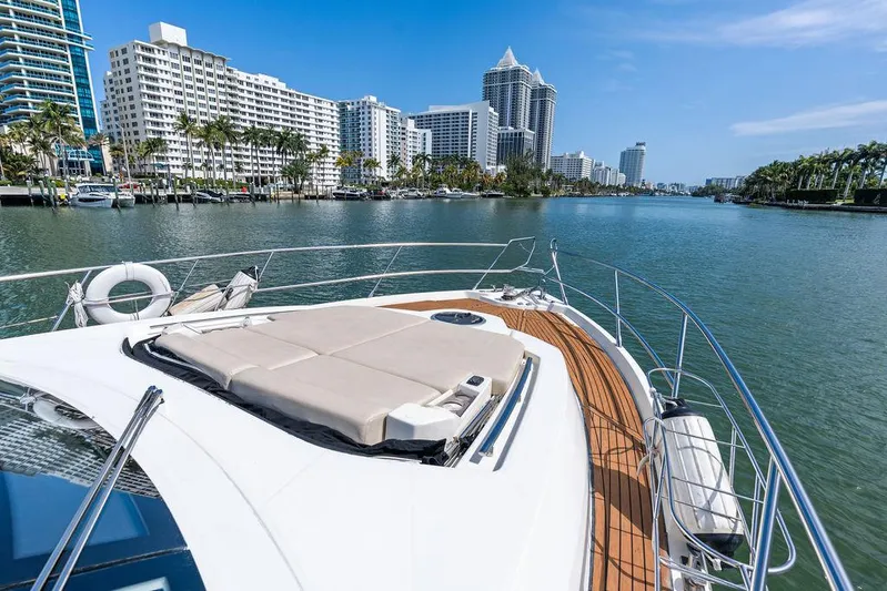 Minion Yacht Photos Pics Cranchi 56 HT yacht cruising near waterfront cityscape, 2014 model.