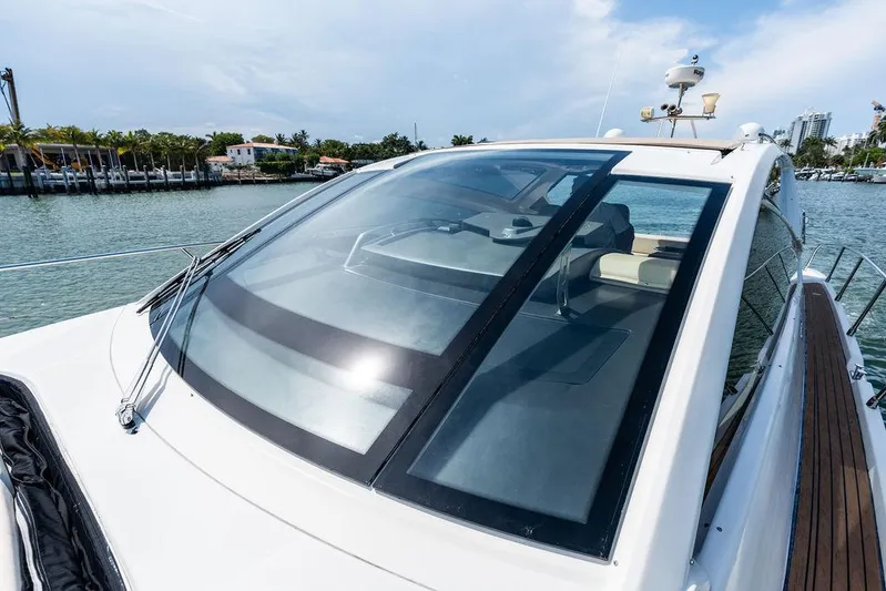 Minion Yacht Photos Pics 2014 Cranchi 56 HT yacht with sleek design, docked by waterfront homes.