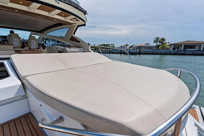 Minion Yacht Photos Pics Luxury Cranchi 56 HT yacht with spacious sunbed, docked by waterfront homes, 2014 model.