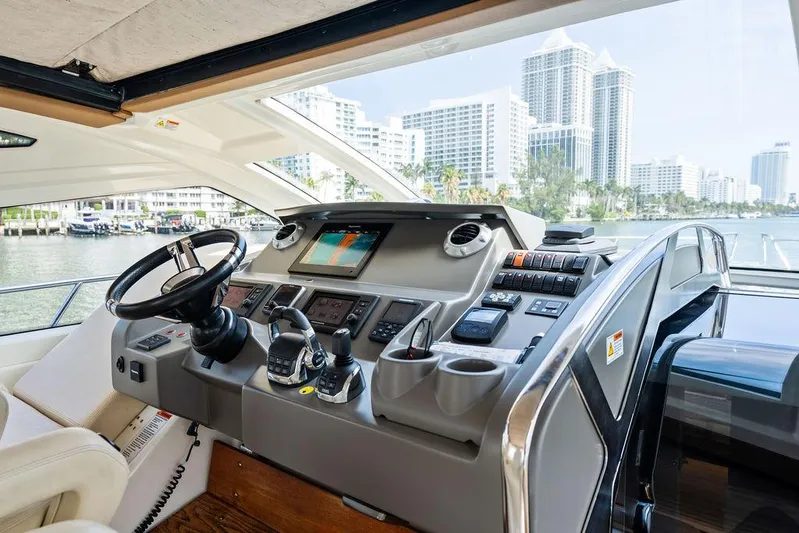 Minion Yacht Photos Pics Helm of 2014 Cranchi 56 HT yacht with city skyline view.