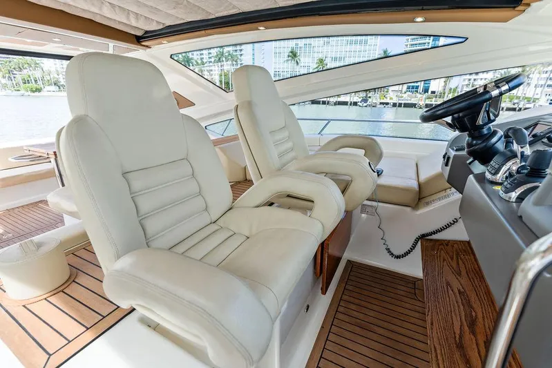 Minion Yacht Photos Pics Luxurious interior of 2014 Cranchi 56 HT yacht with plush seating and modern controls.
