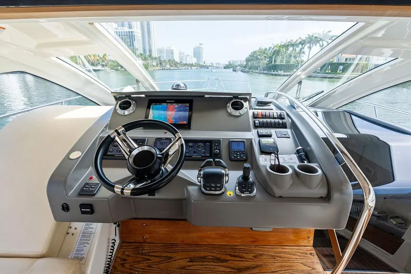 Minion Yacht Photos Pics Helm of 2014 Cranchi 56 HT yacht with modern navigation equipment and waterfront view.