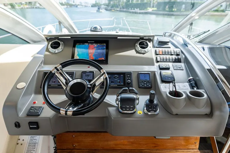 Minion Yacht Photos Pics Helm of 2014 Cranchi 56 HT yacht with modern navigation controls and steering wheel.