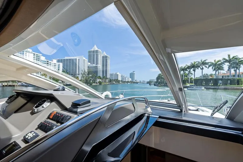 Minion Yacht Photos Pics Interior view from 2014 Cranchi 56 HT yacht, overlooking a city skyline and waterway.