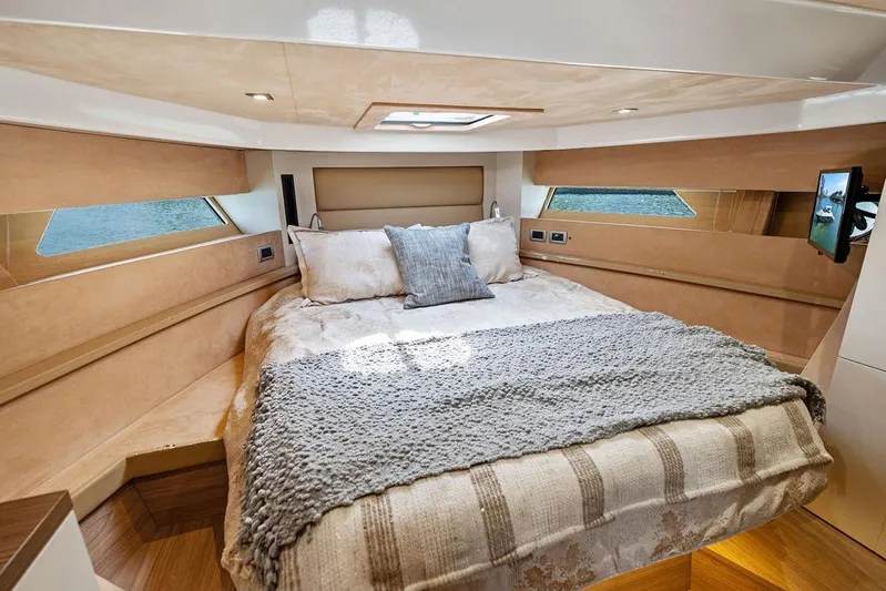 Minion Yacht Photos Pics Luxurious bedroom interior of 2014 Cranchi 56 HT yacht with cozy bedding and natural light.