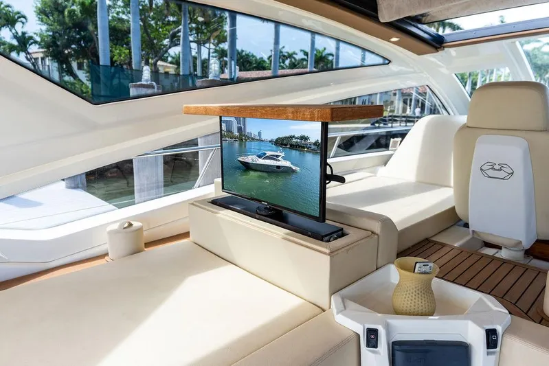 Minion Yacht Photos Pics Luxurious interior of 2014 Cranchi 56 HT yacht with TV and elegant seating.