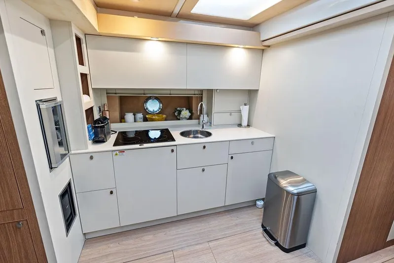 Minion Yacht Photos Pics Modern kitchen interior on 2014 Cranchi 56 HT yacht, featuring sleek cabinetry and appliances.